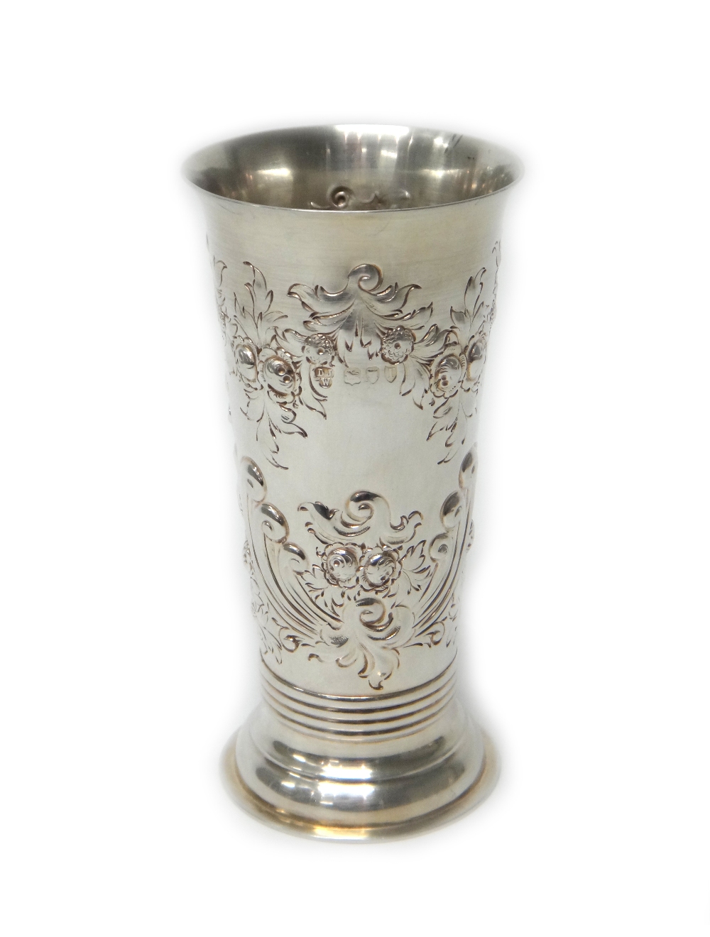 A Victorian silver vase of tapering form, embossed with foliate decoration, London 1894,