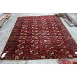 A Tekke Turkman carpet, the madder field with four columns of twelve guls,