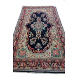A Bakhtiari rug, Persian, the black shaped field with a floral medallion, single floral sprays,