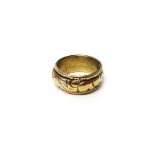 A gold cased poison ring, circa 1840, the rotating central band pierced with a hole,