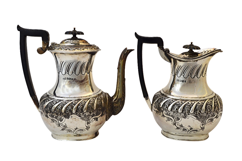 A late Victorian silver coffee pot, with a matching hot milk jug,