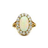 A gold, opal and diamond set oval cluster ring,