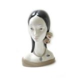 A Lladro porcelain bust depicting a young girl with flowers in her hair, printed mark, 30cm high.