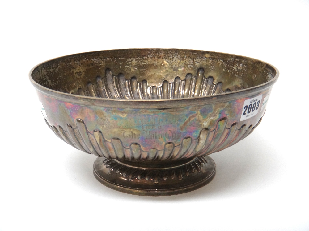 A circular bowl, with semi spiral fluted decoration, on a circular foot,