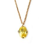 A yellow sapphire set single stone pendant, claw set with an oval cut yellow sapphire,