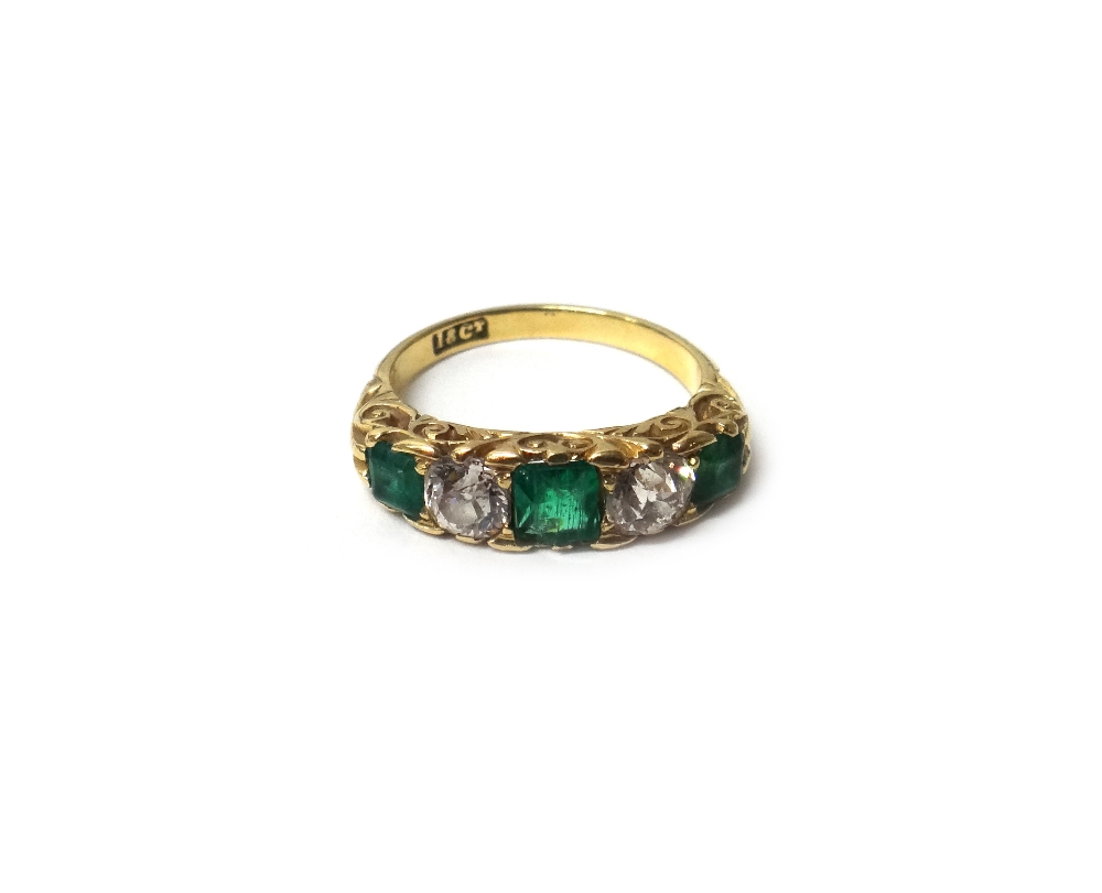 A gold, emerald and diamond five stone ring,