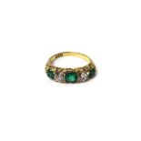 A gold, emerald and diamond five stone ring,