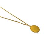 An oval gold pendant, with a gold curb link neckchain, with a hook shaped clasp, probably Oriental,