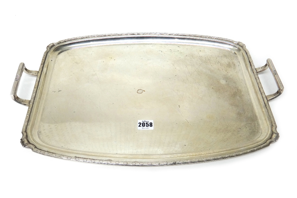 A silver twin handled shaped rectangular tray, having a decorated rim in the Art Deco style,