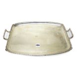 A silver twin handled shaped rectangular tray, having a decorated rim in the Art Deco style,