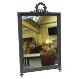 An Edwardian silvered toilet mirror, with ribbon tied acorn and oak leaf cresting and easel support,