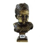 An early 20th century patinated bronze bust cast as a young child, on a footed base, unsigned, 25.