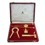 An 'Asprey' gilt metal four piece bottle opening set in a fitted case and box,