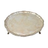 A silver salver, of shaped circular form, in the Chippendale style,