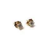 A pair of gold and diamond set single stone earstuds, each mounted with a circular cut diamond,