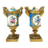 A pair of Sevres style porcelain and ormolu mounted two handled urns and covers,