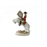 A Vienna porcelain figure of a cavalry officer on a rearing horse,