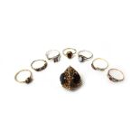 A 9ct gold and smoky quartz set three stone pendant, designed as a stylized lantern,