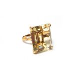 A gold ring, claw set with a rectangular step cut citrine, ring size M, with a case.