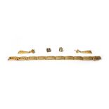 A gold bracelet, pierced in a Greek key pattern curved rectangular link design, on a snap clasp,