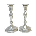 A pair of silver table candlesticks, each with an octagonal baluster stem,