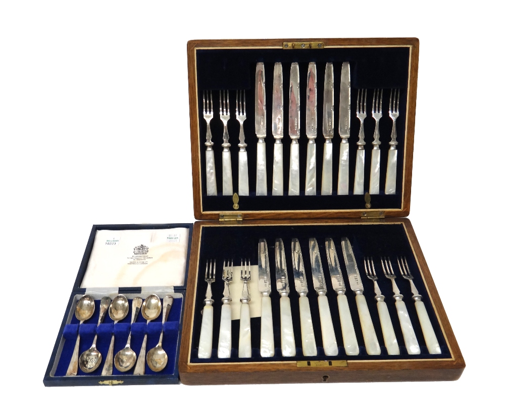 A set of twelve pairs of silver dessert or fruit knives and forks,