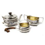 A George III silver composite three piece tea set, comprising; a teapot,