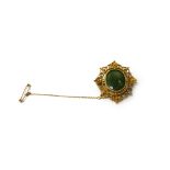 A gold mounted carved green hardstone oval intaglio brooch,