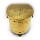 An Art Nouveau brass coal box, of rounded design with hinged cover and shaped feet, 32cm across.