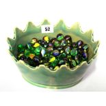 A large collection of vintage glass marbles in an oval green glazed Monteith style bowl (qty).