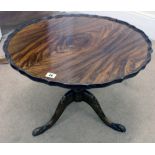 A reproduction mahogany shaped circular low centre table, on tripod base,