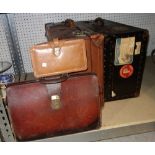 A leather suitcase with Union Castle labels, another black trunk with Cunard White Star Line labels,