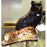 A large 20th century black ceramic cat and a smaller leopard, (2).