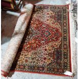 A machine made rug, 194cm x 133cm.