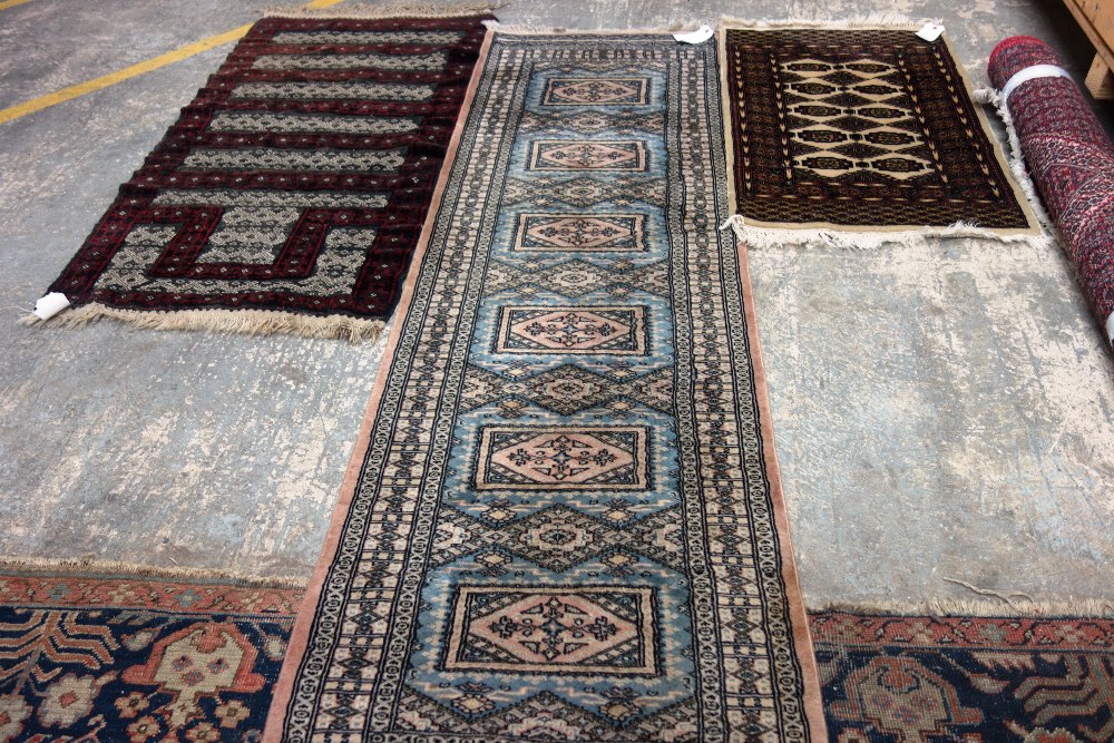 A Pakistan runner of blue field with six medallions, 250cm x 77cm, a Pakistan rug, 113cm x 78cm,