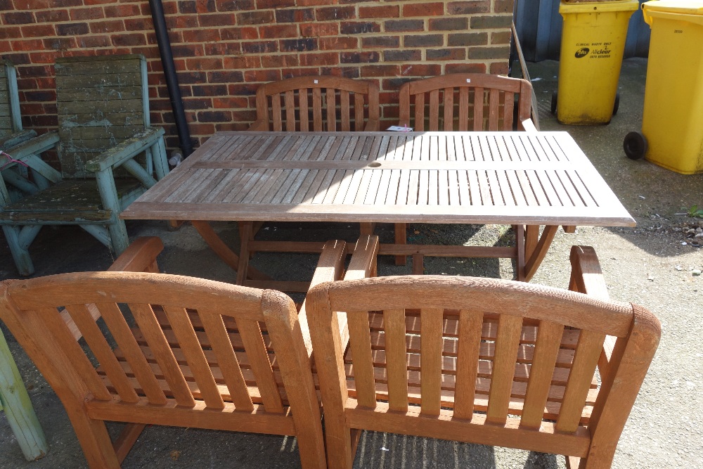 A rectangular teak garden table, together with four open armchairs, (5).