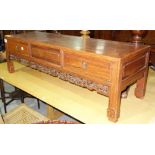 An early 20th century Chinese hardwood low table with two drawers and carved frieze, 100cm wide.