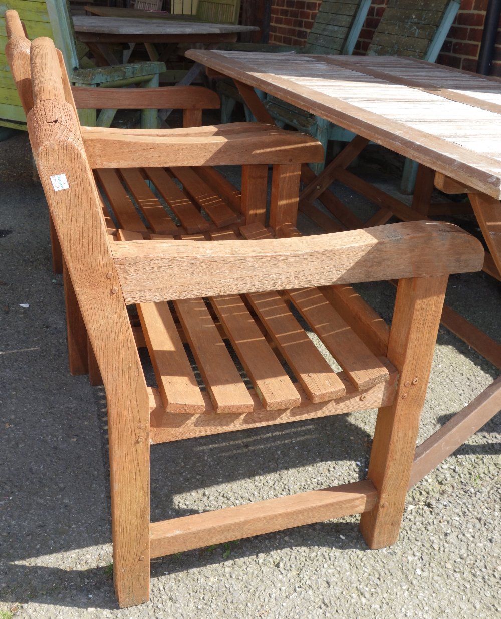 A rectangular teak garden table, together with four open armchairs, (5). - Image 2 of 2