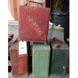 A group of four metal vintage petrol cans including Shell and Pratt.