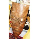 A 20th century copper tribal style mask on stand.