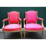 A pair of Louis XVI style pink upholstered open armchairs,