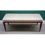 A rectangular footstool on four William IV mahogany reeded supports, 120cm wide x 50cm deep.