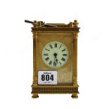 A gilt brass cased carriage clock, early 20th century, with white enamel dial and engraved plate,
