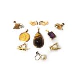 A gold pendant, mounted with a drop shaped tiger's eye, detailed 9 CT,