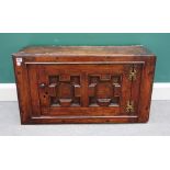 A Charles II hanging single door cupboard with geometric moulding, 86cm wide x 47cm high.