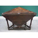 An early 18th century oak corner drop flap/ handkerchief table on turned supports,