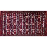 A Yumut carpet, the field with bands bearing guls, a minor diamond border, skirt end, 308cm x 172cm.