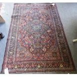 A pair of Teheran rugs, Persian, each madder field with a dark and pale indigo medallion,