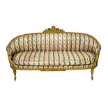 A Louis XVI cream painted tub back sofa, with torch and quiver carved crest on fluted supports,