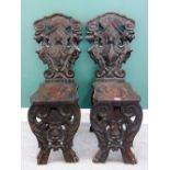 A pair of 17th century style Italian carved walnut side chairs, of Sgabello design,